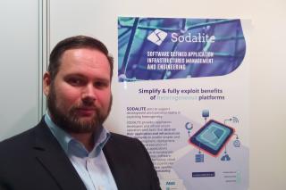 Paul Mundt (Innovation Manager) showing SODALITE poster at the booth